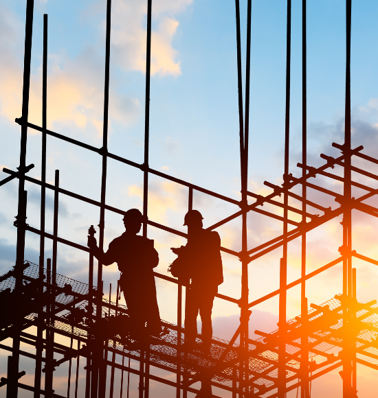 two people on a construction site with sunrise in the background.