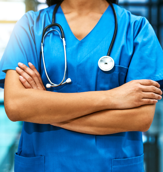 Doctor in scrubs with arms crossed