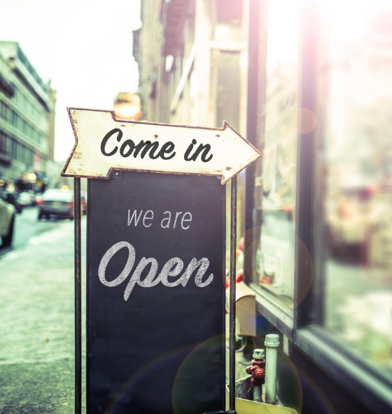 Picture of sign that says "We are Open" at a business.